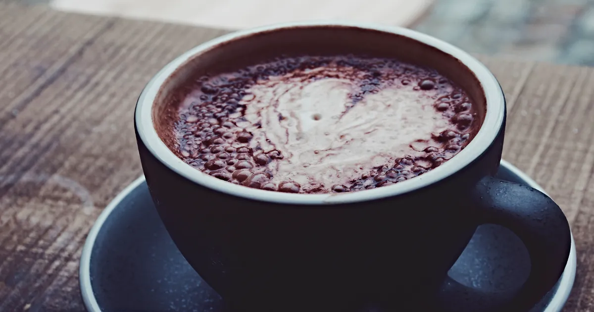 Hot chocolate with heart shape in a brown mug